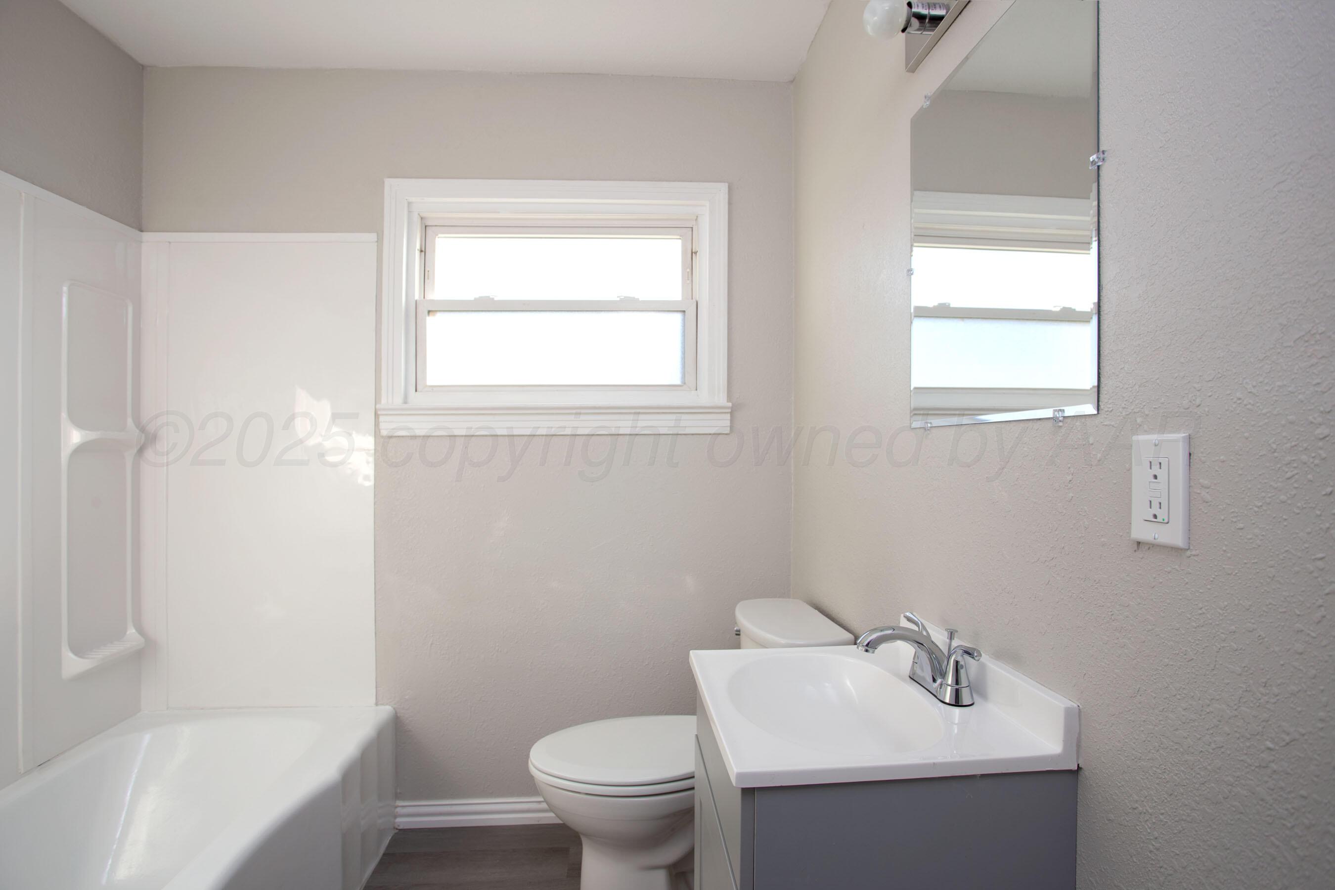 1928 Cherry Street Amarillo, TX 79106 - Photo 14 of 24 a bathroom with a sink toilet and shower