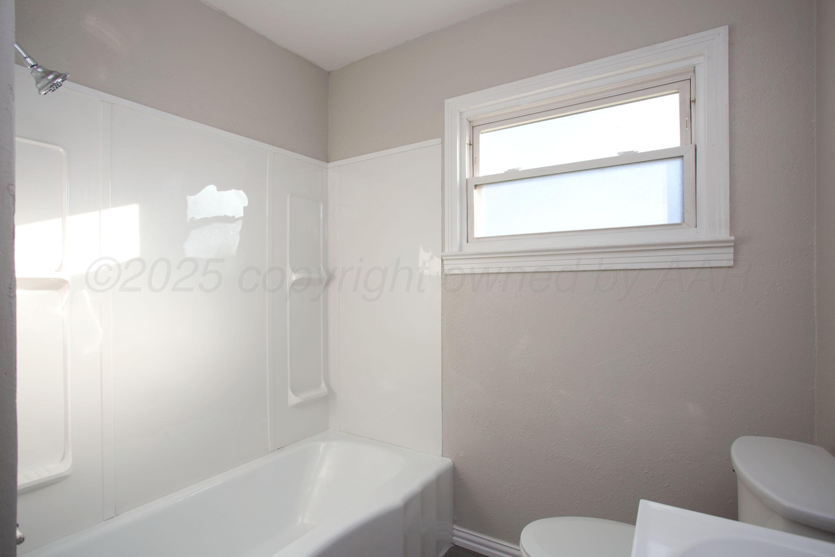 1928 Cherry Street Amarillo, TX 79106 - Photo 15 of 24 a bathroom with a toilet and a bathtub