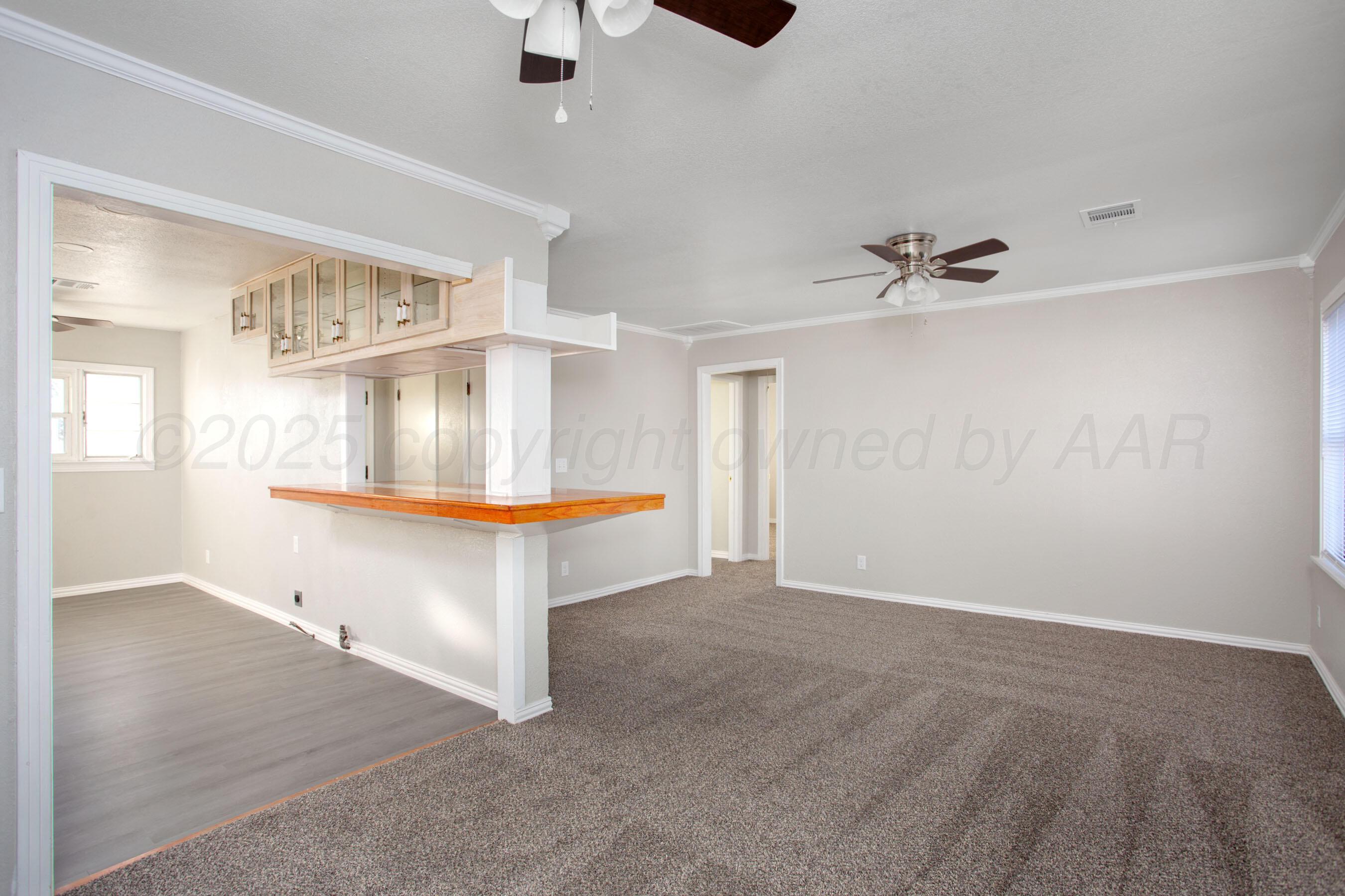 1928 Cherry Street Amarillo, TX 79106 - Photo 7 of 24 wooden floor in an empty room with a window