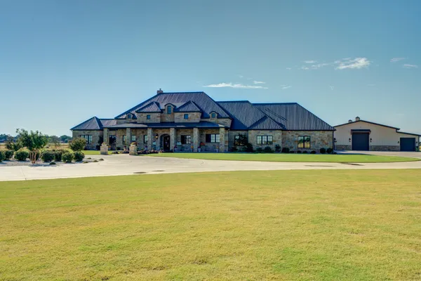 a large kitchen with stainless steel appliances granite countertop a stove a sink and a refrigerator