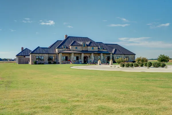 a kitchen with stainless steel appliances granite countertop a sink a stove and a wooden floors