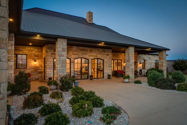 a front view of house with yard and outdoor seating
