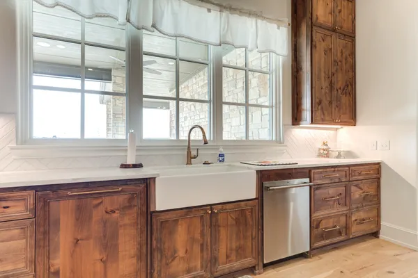a view of an empty room with wooden fence