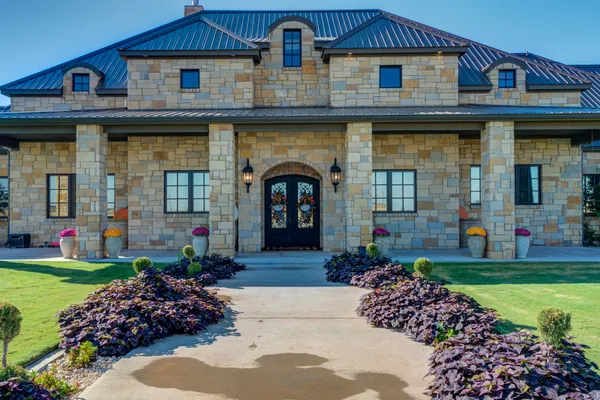a front view of a house with outdoor seating