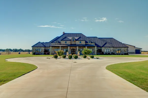 a living room with furniture white walls and a chandelier