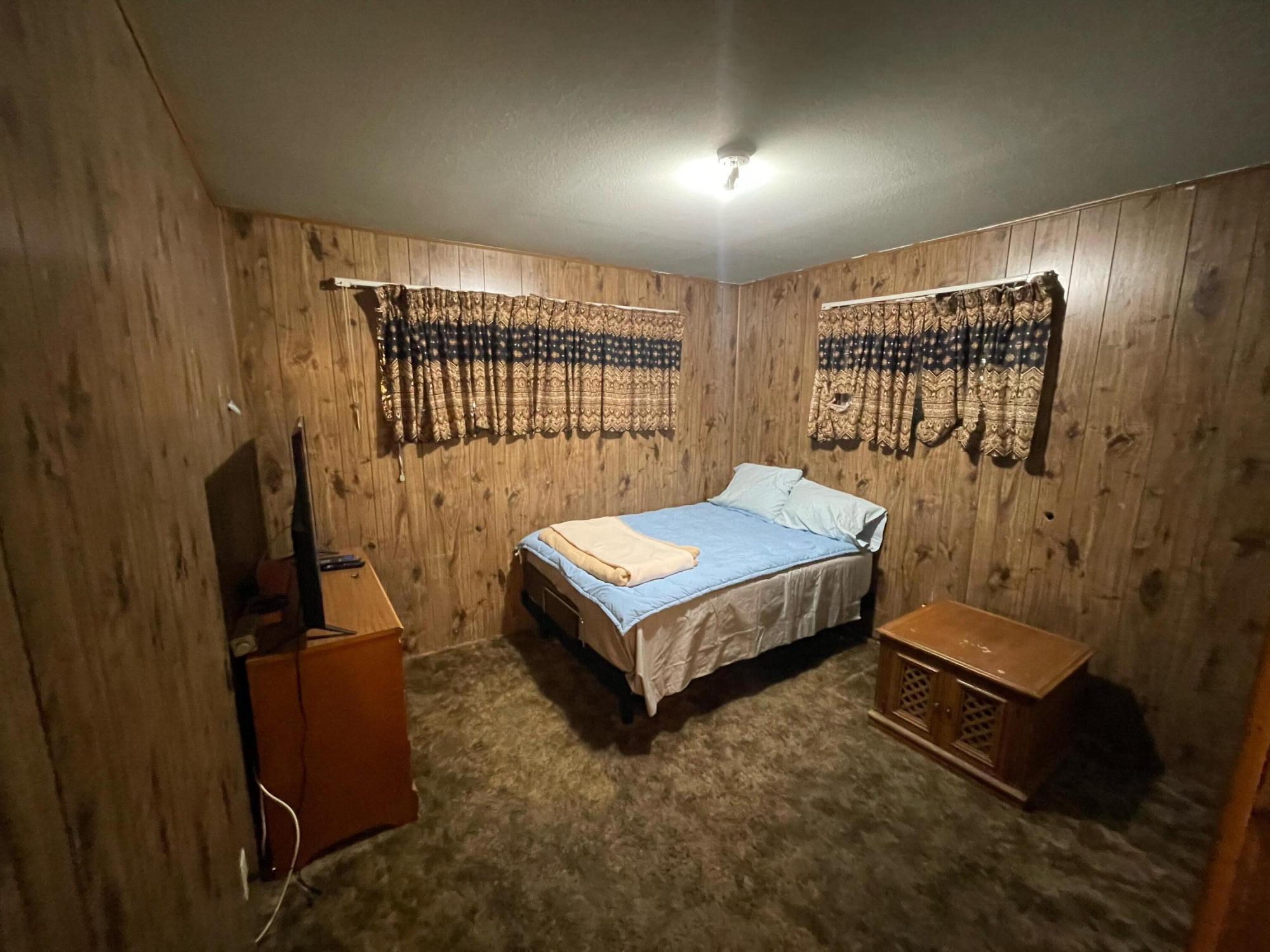 82785 Smoke Tree Avenue Indio, CA 92201 - Photo 5 of 7 a bedroom with a bed and wooden floor