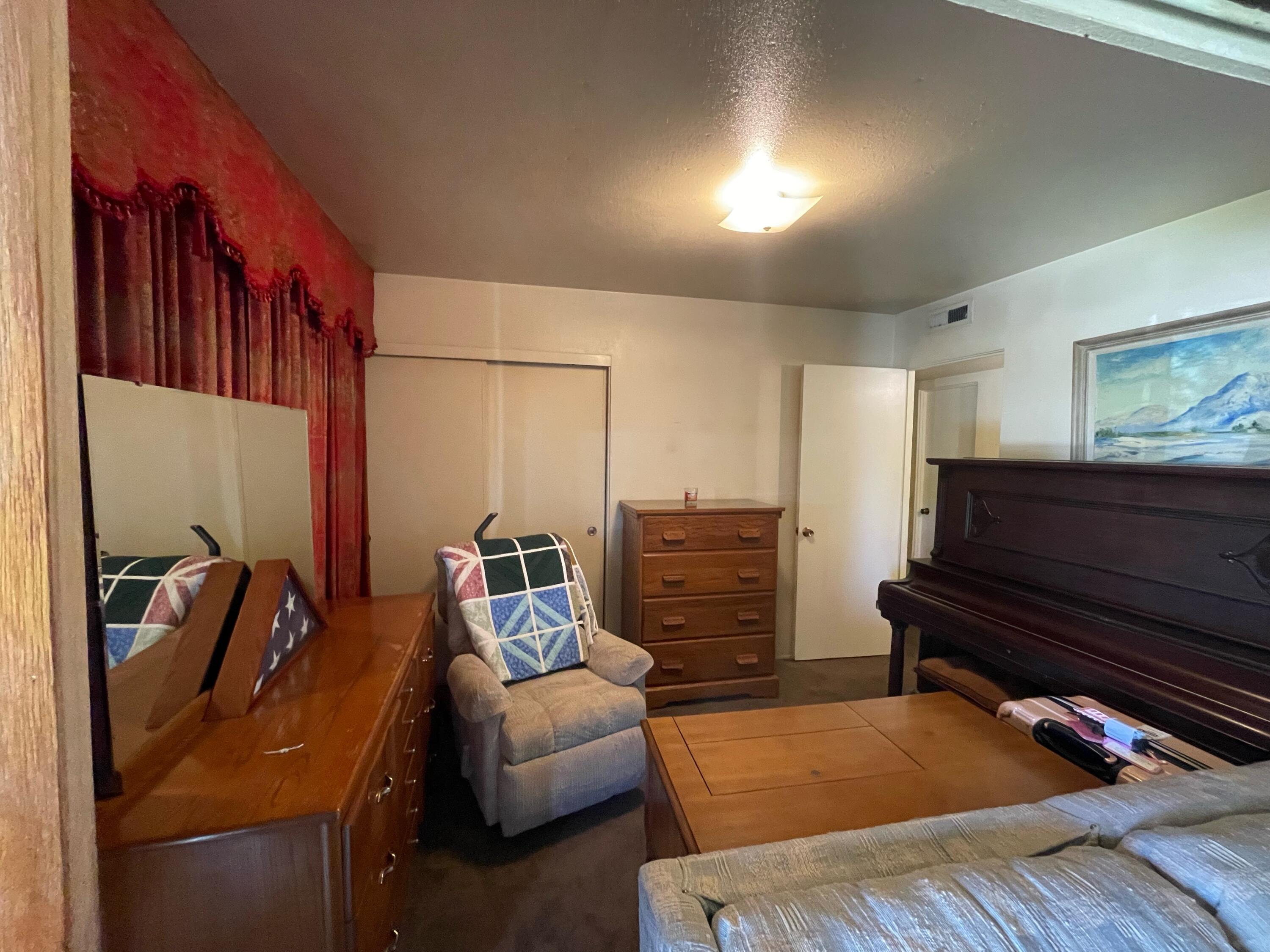 82785 Smoke Tree Avenue Indio, CA 92201 - Photo 6 of 7 a bedroom with furniture and a rug