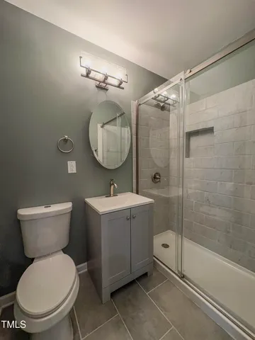 a bathroom with a toilet sink and shower