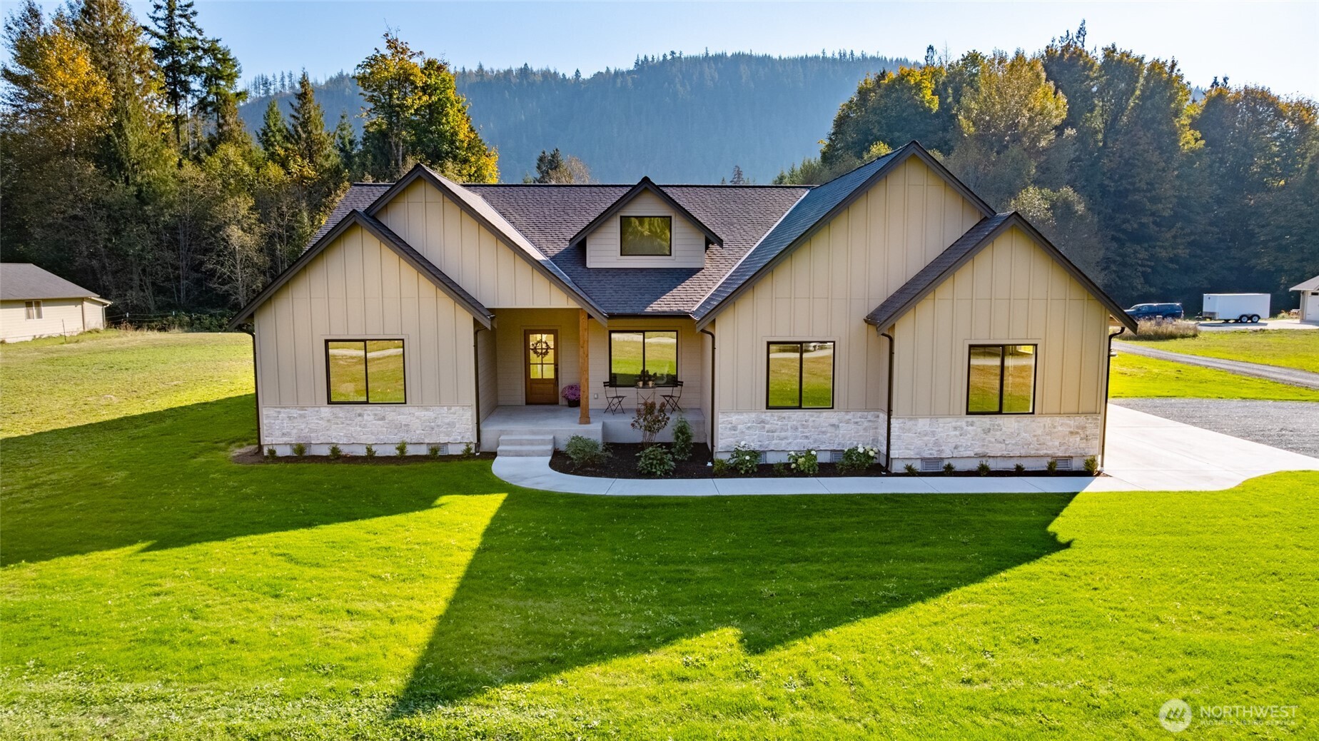 a front view of a house with a yard table and chairs