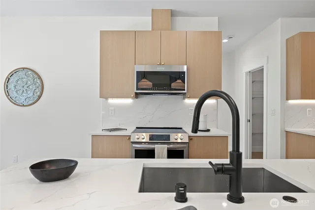 a kitchen with a sink a stove and cabinets