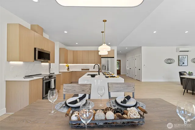 a view of a kitchen with kitchen island granite countertop a stove and a sink