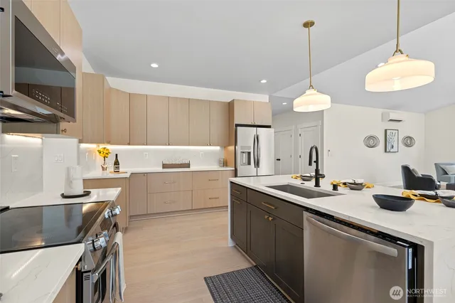 a kitchen with a sink appliances and cabinets