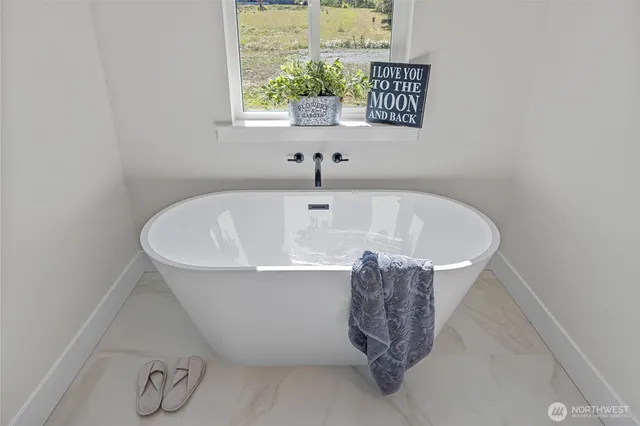 a white bath tub sitting next to a window