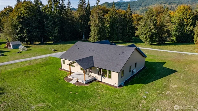 a aerial view of a house with a yard table and chairs
