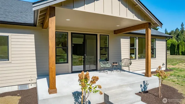 a view of a patio with table and chairs and potted plants