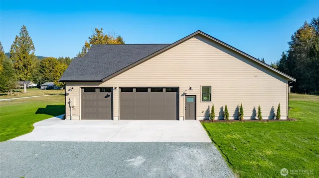 a front view of a house with yard and green space