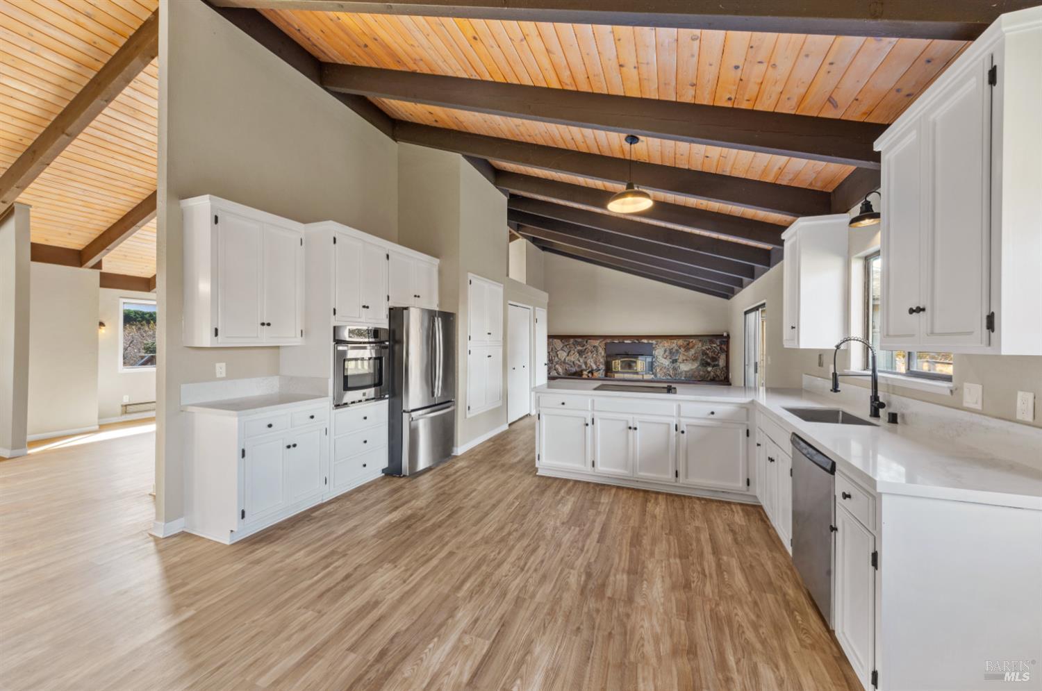 5 Mc Donald Lane Point Reyes Station, CA 94956 - Photo 12 of 48 a large kitchen with cabinets wooden floor and stainless steel appliances