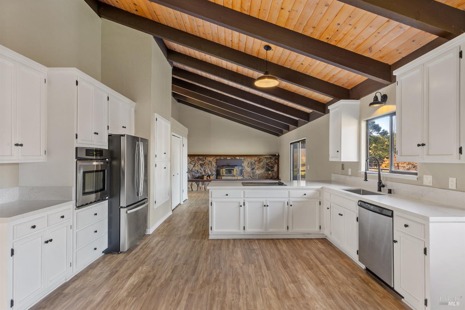 5 Mc Donald Lane Point Reyes Station, CA 94956 - Photo 13 of 48 a kitchen with granite countertop a sink stainless steel appliances and cabinets