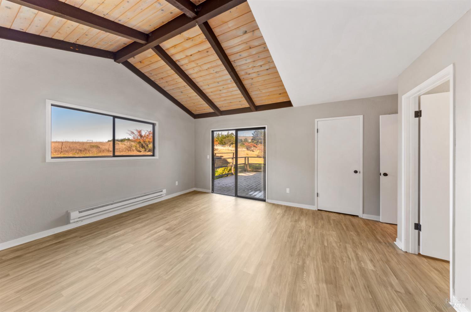 5 Mc Donald Lane Point Reyes Station, CA 94956 - Photo 22 of 48 a view of an empty room with wooden floor and a window
