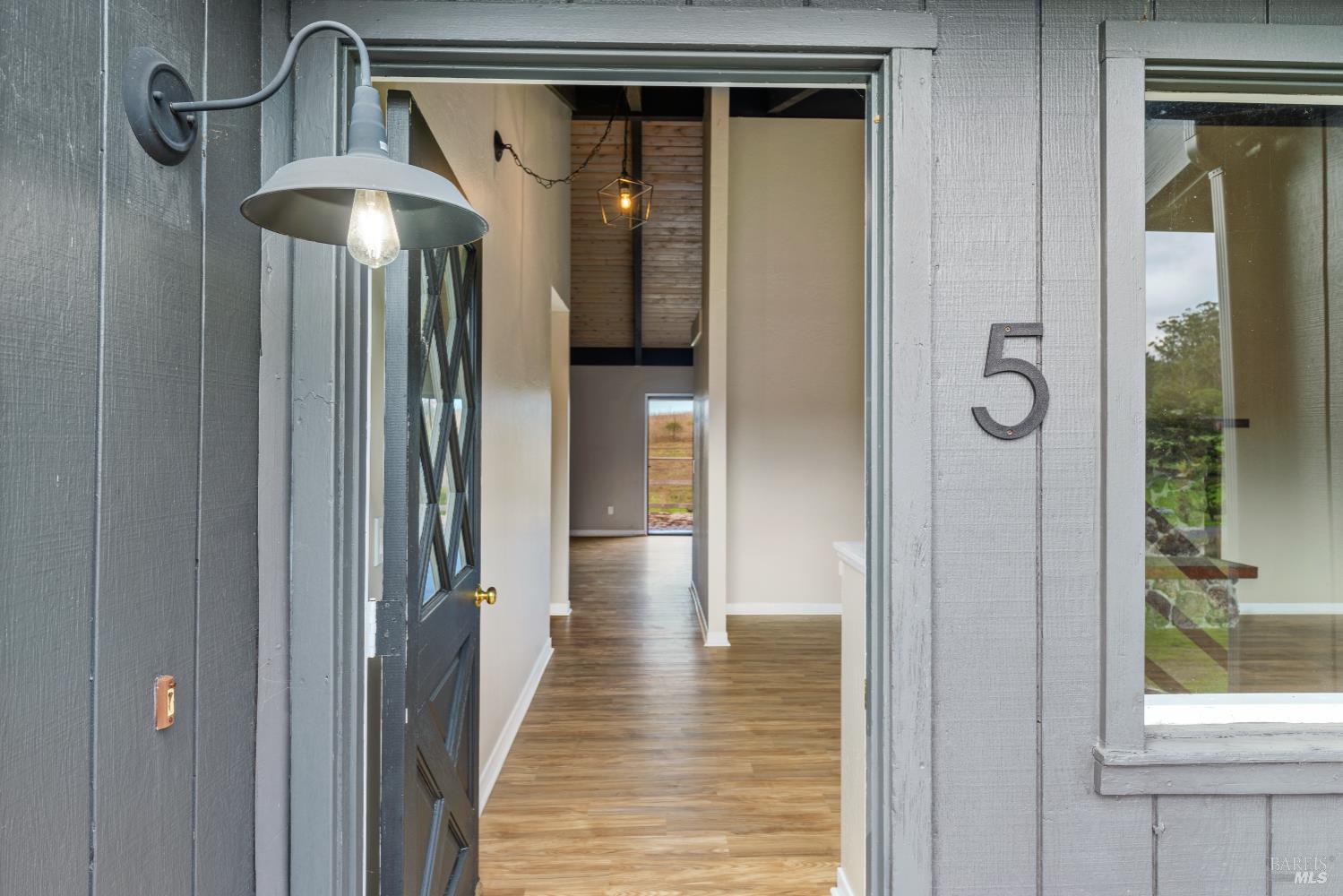 5 Mc Donald Lane Point Reyes Station, CA 94956 - Photo 4 of 48 a view of a hallway with wooden floor and staircase
