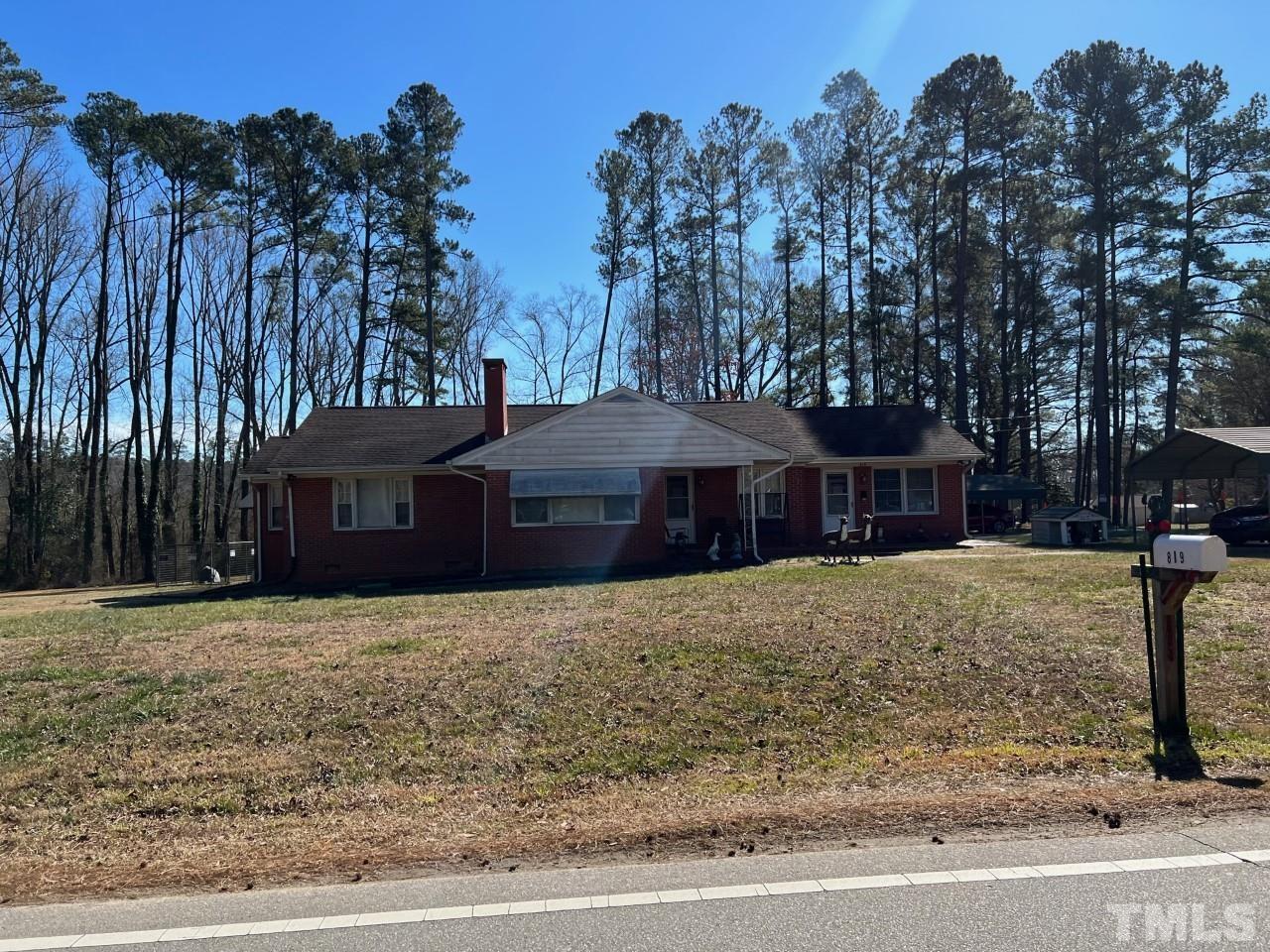 819 Woodland Road Raleigh, NC 27603 - Photo 3 of 16 a front view of a house with a yard and trees
