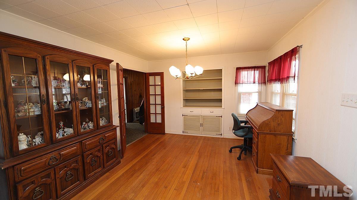 819 Woodland Road Raleigh, NC 27603 - Photo 7 of 16 a view of a livingroom with furniture window and wooden floor