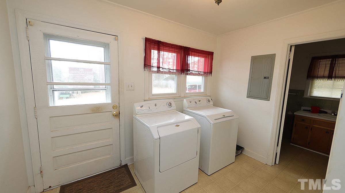 819 Woodland Road Raleigh, NC 27603 - Photo 9 of 16 a view of storage and utility room with washer and dryer