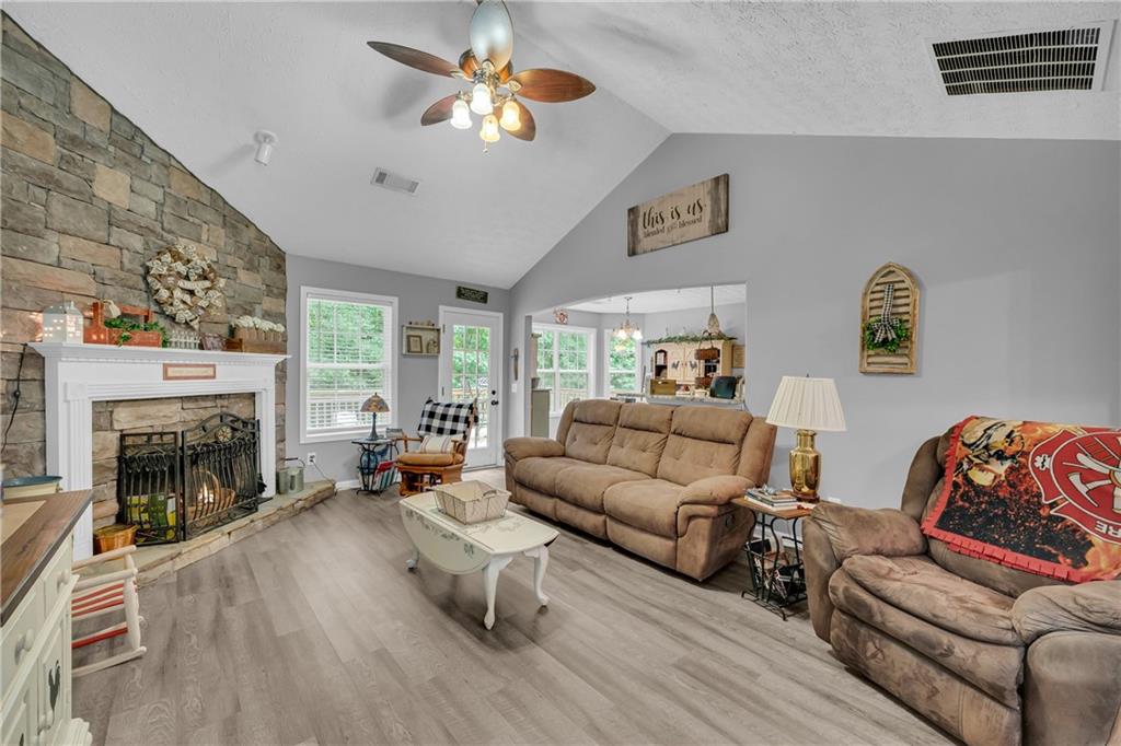 587-j B J B Owens Road Bethlehem, GA 30620 - Photo 25 of 99 a living room with furniture fireplace and a large window