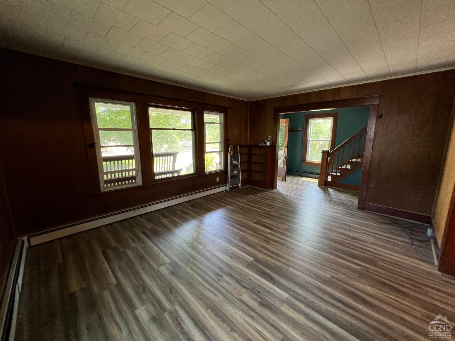 163 Spring Street Catskill, NY 12414 - Photo 14 of 36 wooden floor in an empty room with a window