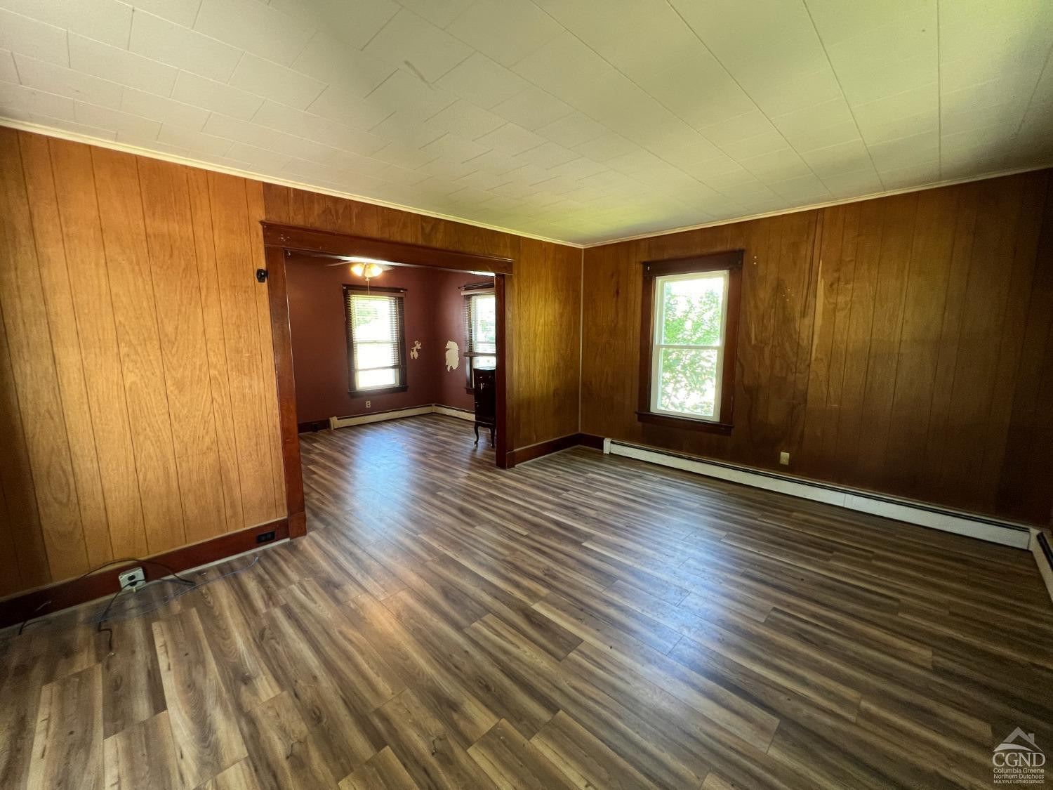 163 Spring Street Catskill, NY 12414 - Photo 16 of 36 an empty room with wooden floor and windows