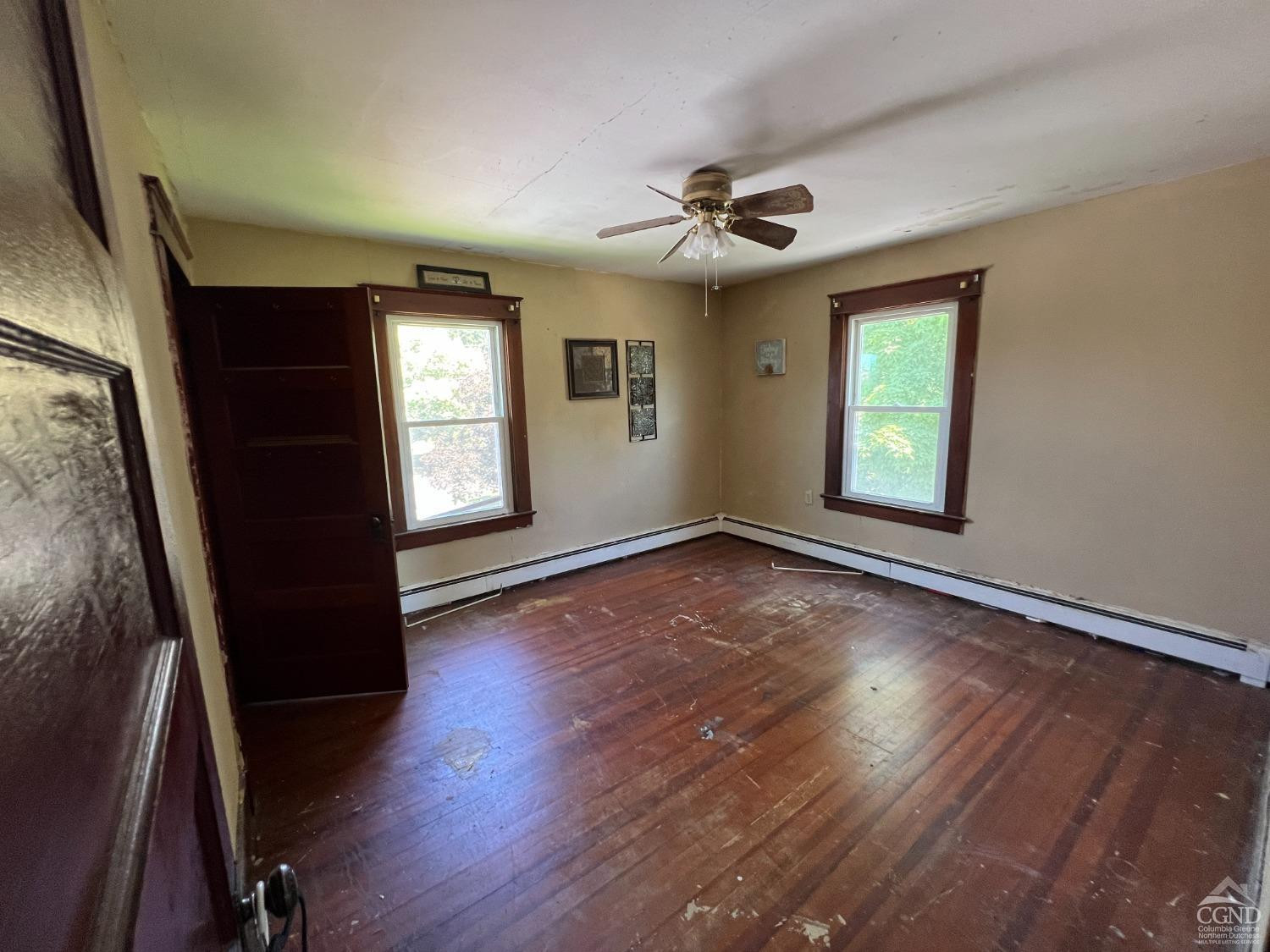 163 Spring Street Catskill, NY 12414 - Photo 23 of 36 a view of an empty room with a window and wooden floor