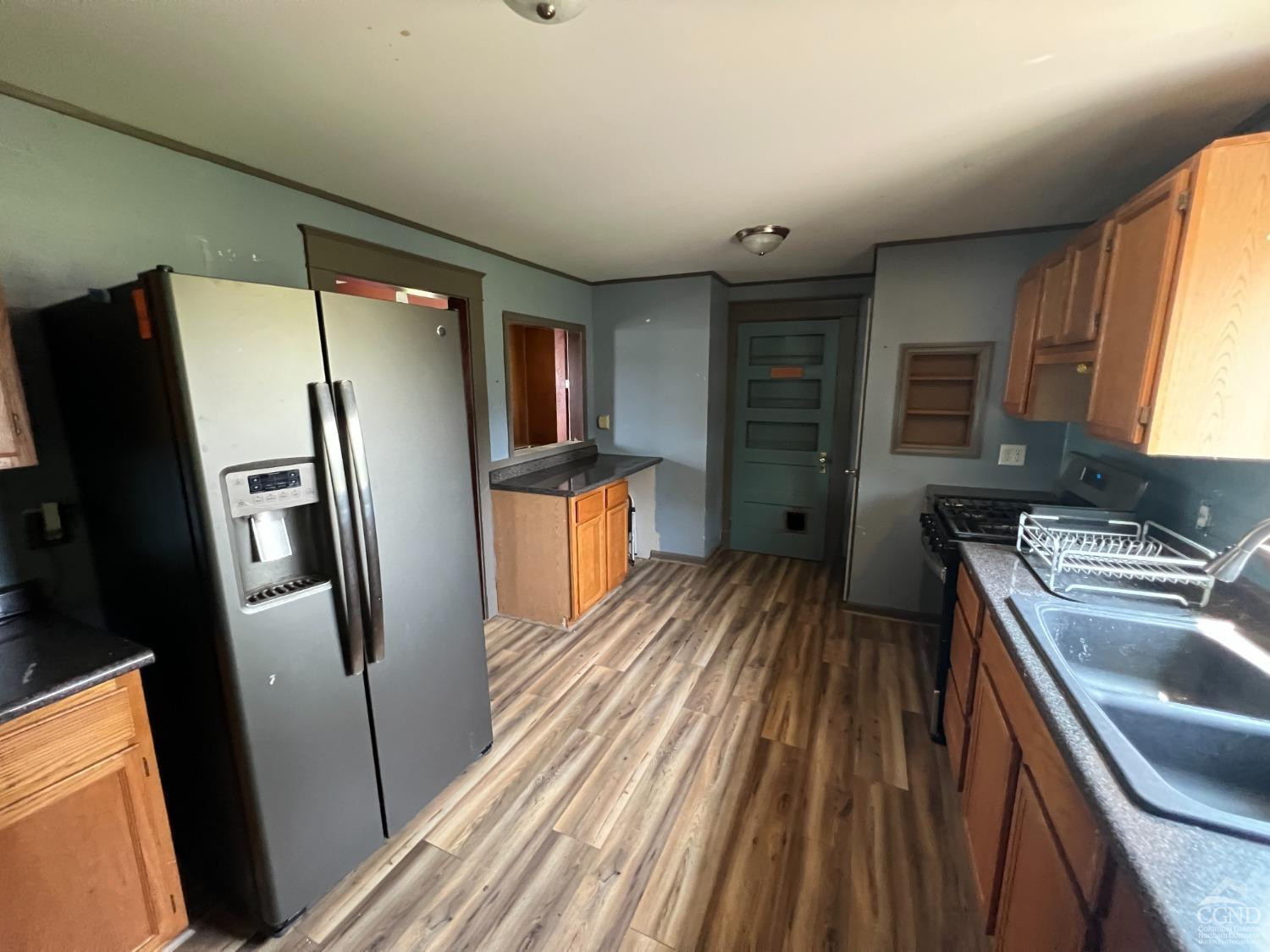 163 Spring Street Catskill, NY 12414 - Photo 5 of 36 a kitchen with stainless steel appliances granite countertop a refrigerator and a sink