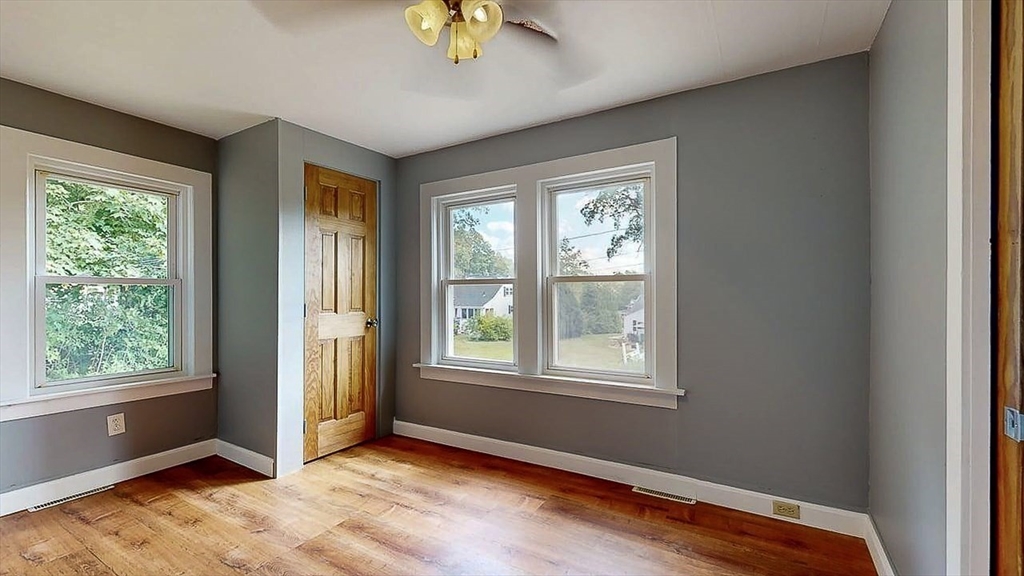 10 Overlook Avenue Charlton, MA 01507 - Photo 22 of 40 a view of an empty room with window and wooden floor