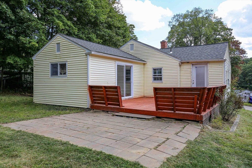 10 Overlook Avenue Charlton, MA 01507 - Photo 32 of 40 a backyard of a house with wooden fence and large trees