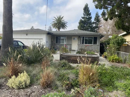 a front view of house with yard and outdoor seating