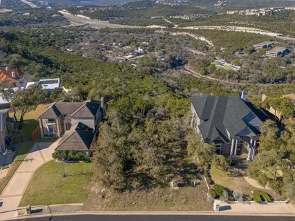an aerial view of houses with a lake