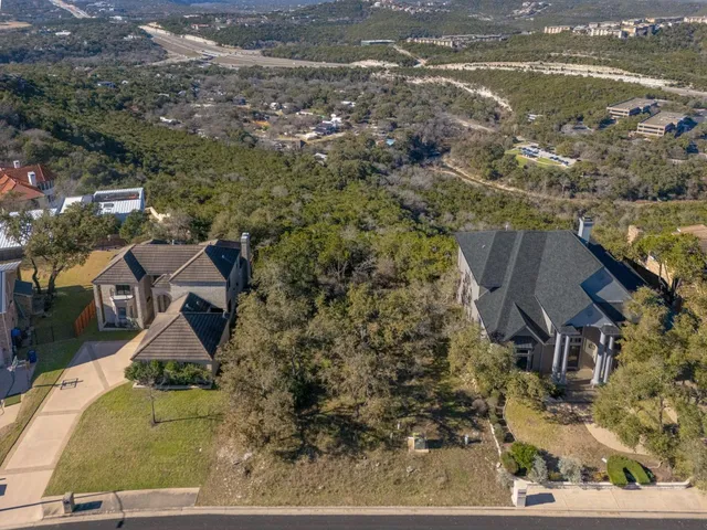 an aerial view of houses with a lake
