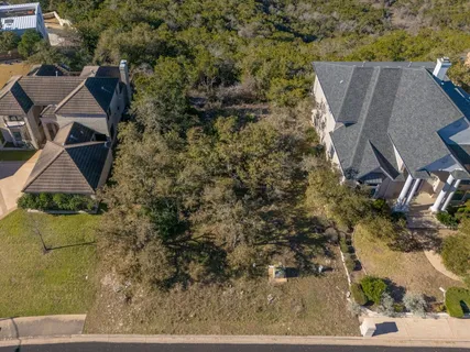 an aerial view of a house with yard and mountain view