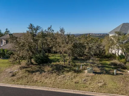 a view of a yard with wooden fence