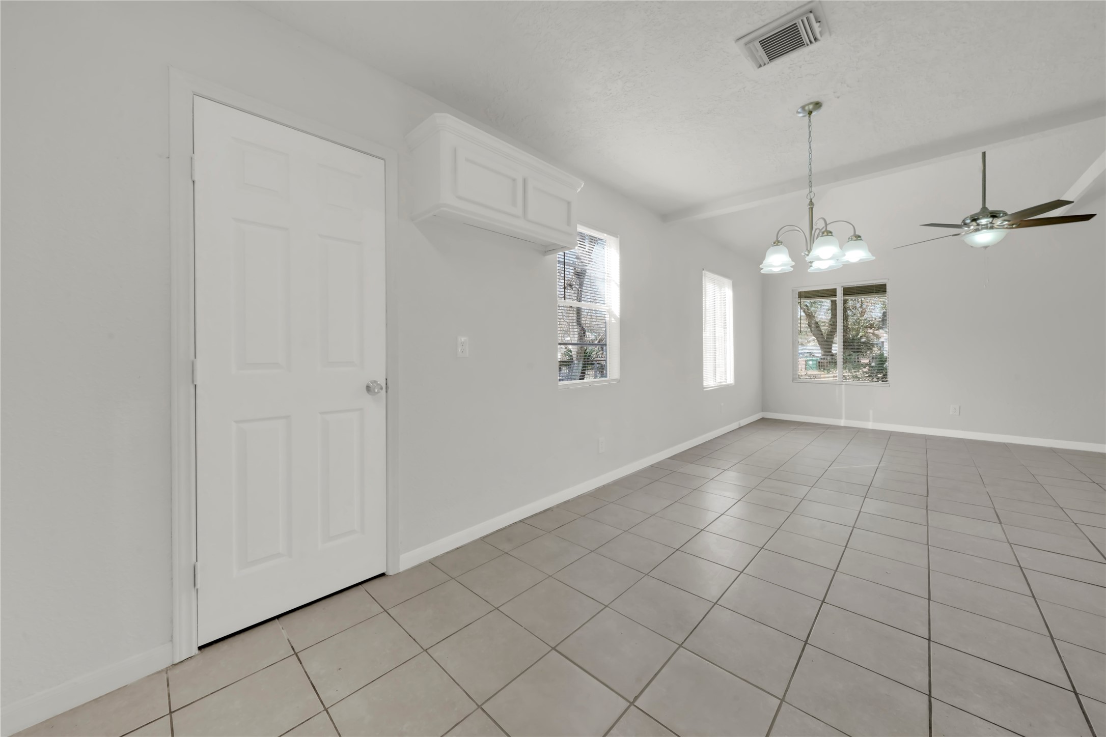 106 Hanover Street Houston, TX 77012 - Photo 11 of 49 a view of an empty room with window and chandelier fan