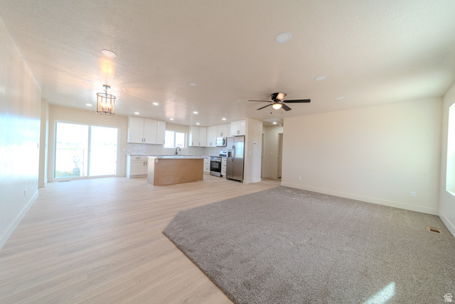 130 Pole Line Road, Unit 2 Roosevelt, UT 84066 - Photo 7 of 33 Open-concept living area featuring light wood-finish flooring, recessed lighting, and a contemporary ceiling fan