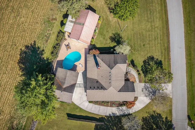 a view of a house with backyard and sitting area