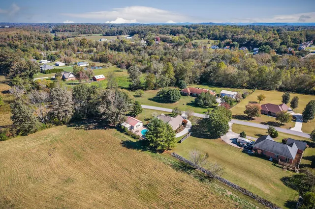 a kitchen with granite countertop a refrigerator stove and sink