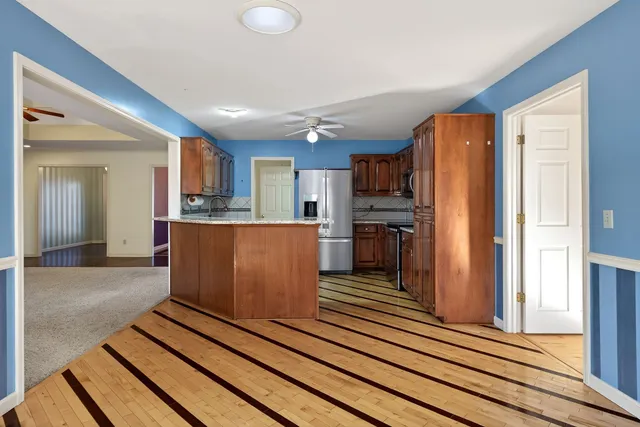 a kitchen with granite countertop a sink and dishwasher wooden cabinets with granite countertops