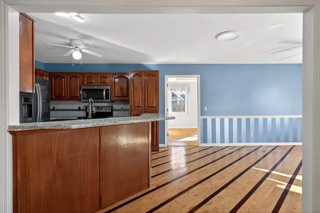 a view of a livingroom with a fireplace and window