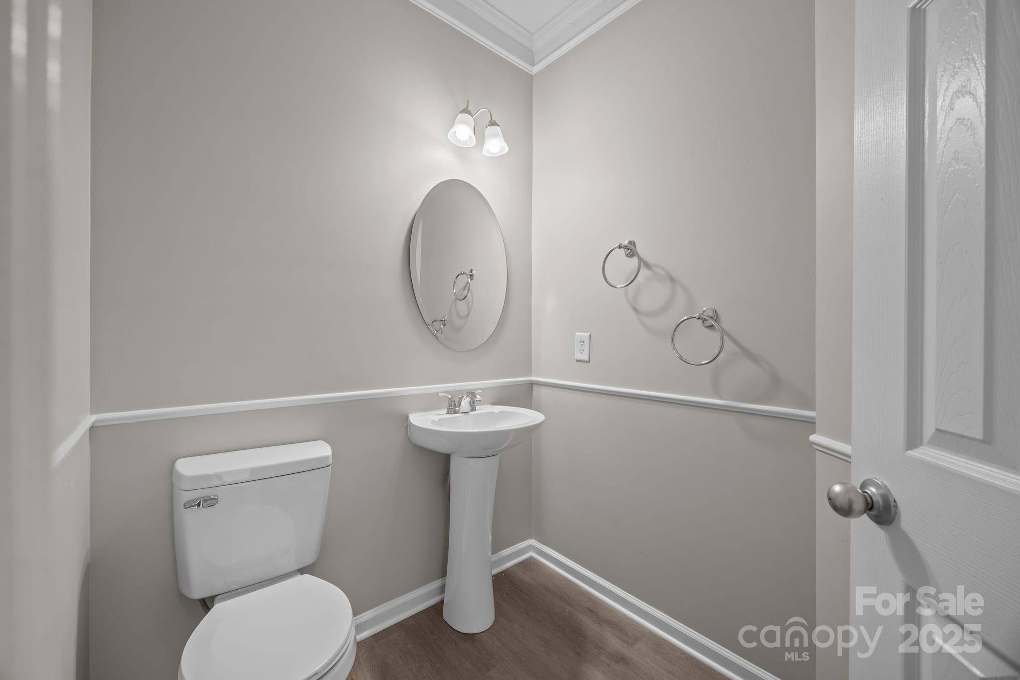 3422 Burnage Hall Road Harrisburg, NC 28075 - Photo 11 of 42 a bathroom with a toilet a sink and mirror