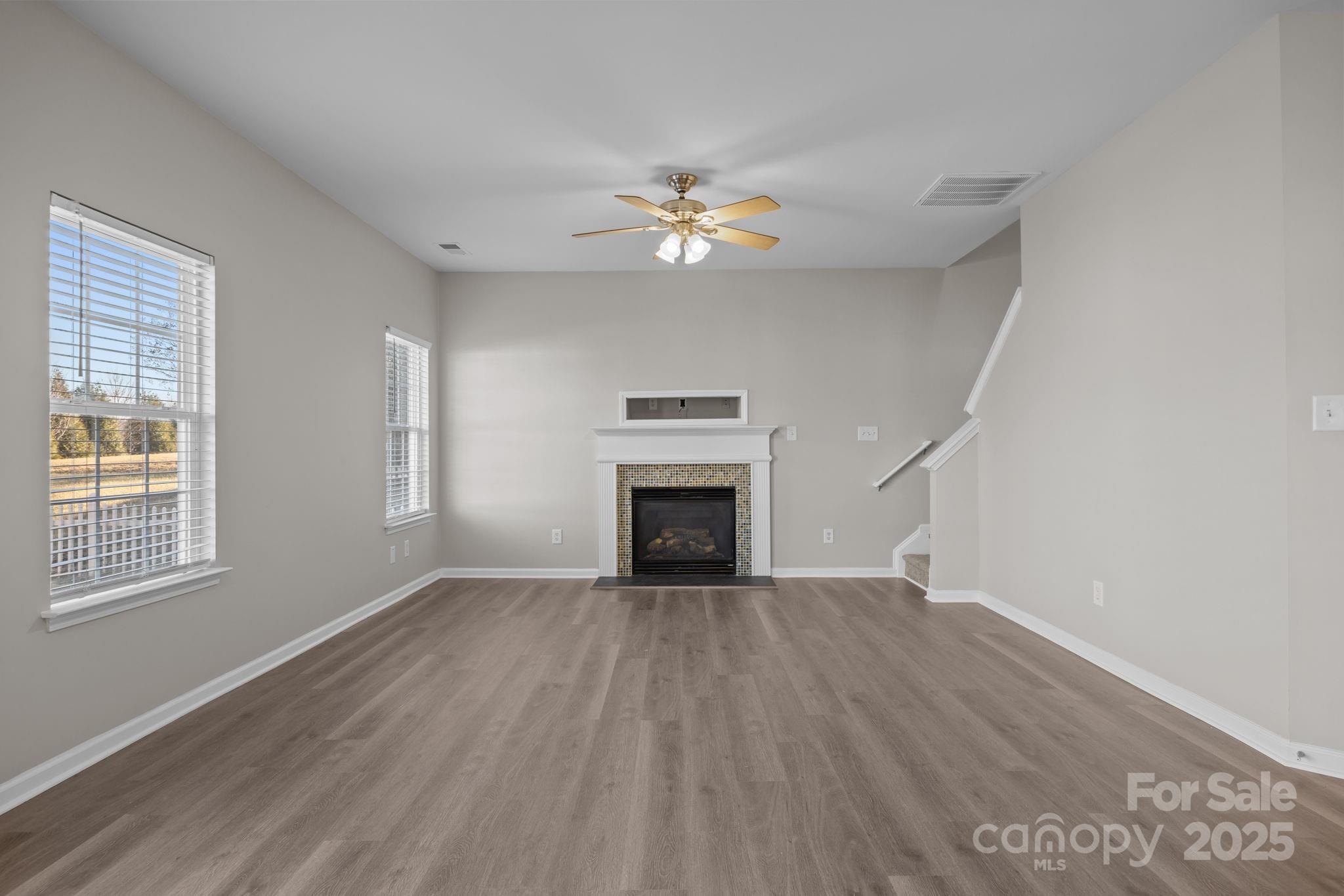 3422 Burnage Hall Road Harrisburg, NC 28075 - Photo 13 of 42 an empty room with windows and fireplace