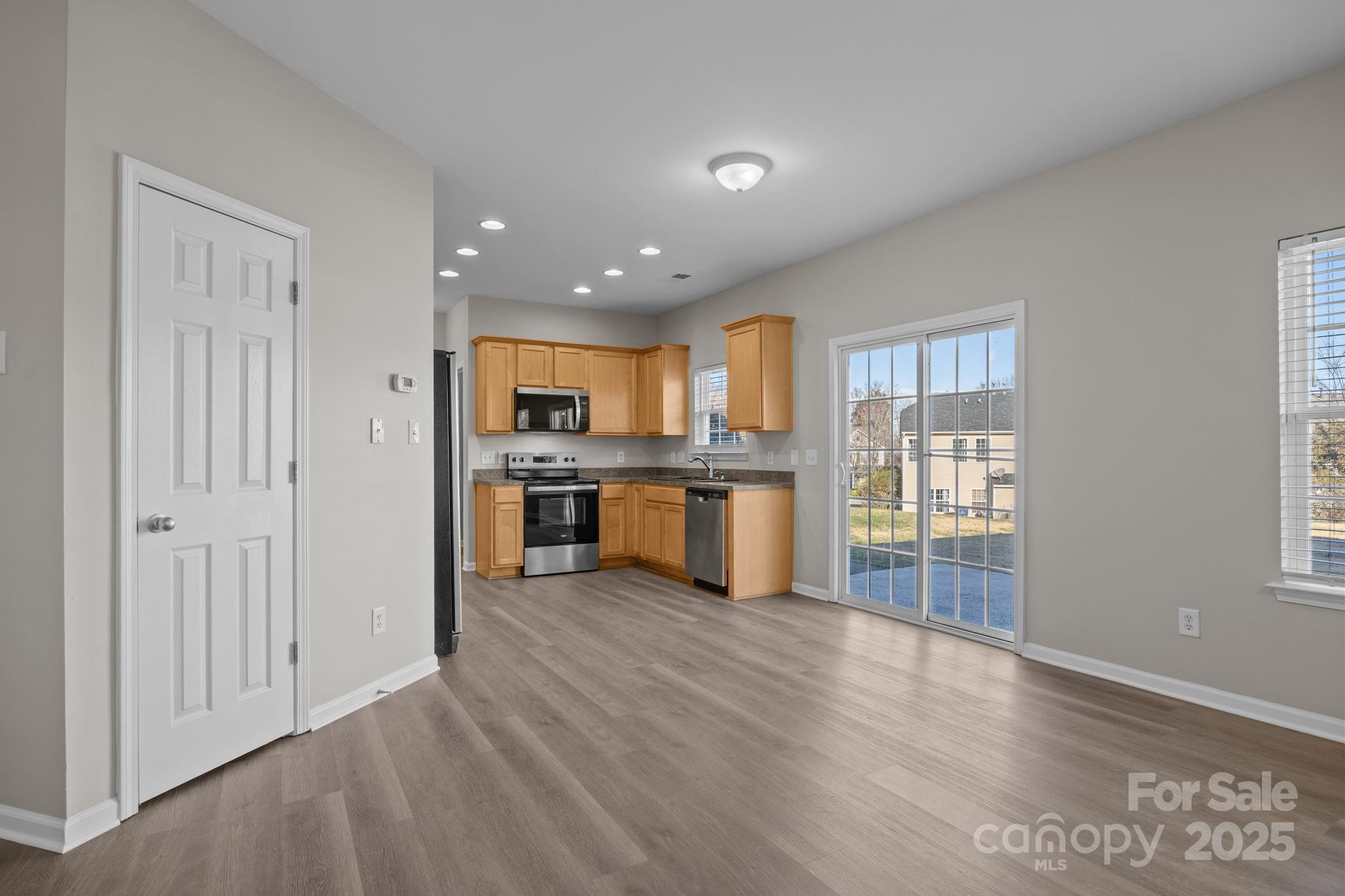 3422 Burnage Hall Road Harrisburg, NC 28075 - Photo 16 of 42 a view of kitchen with wooden floor