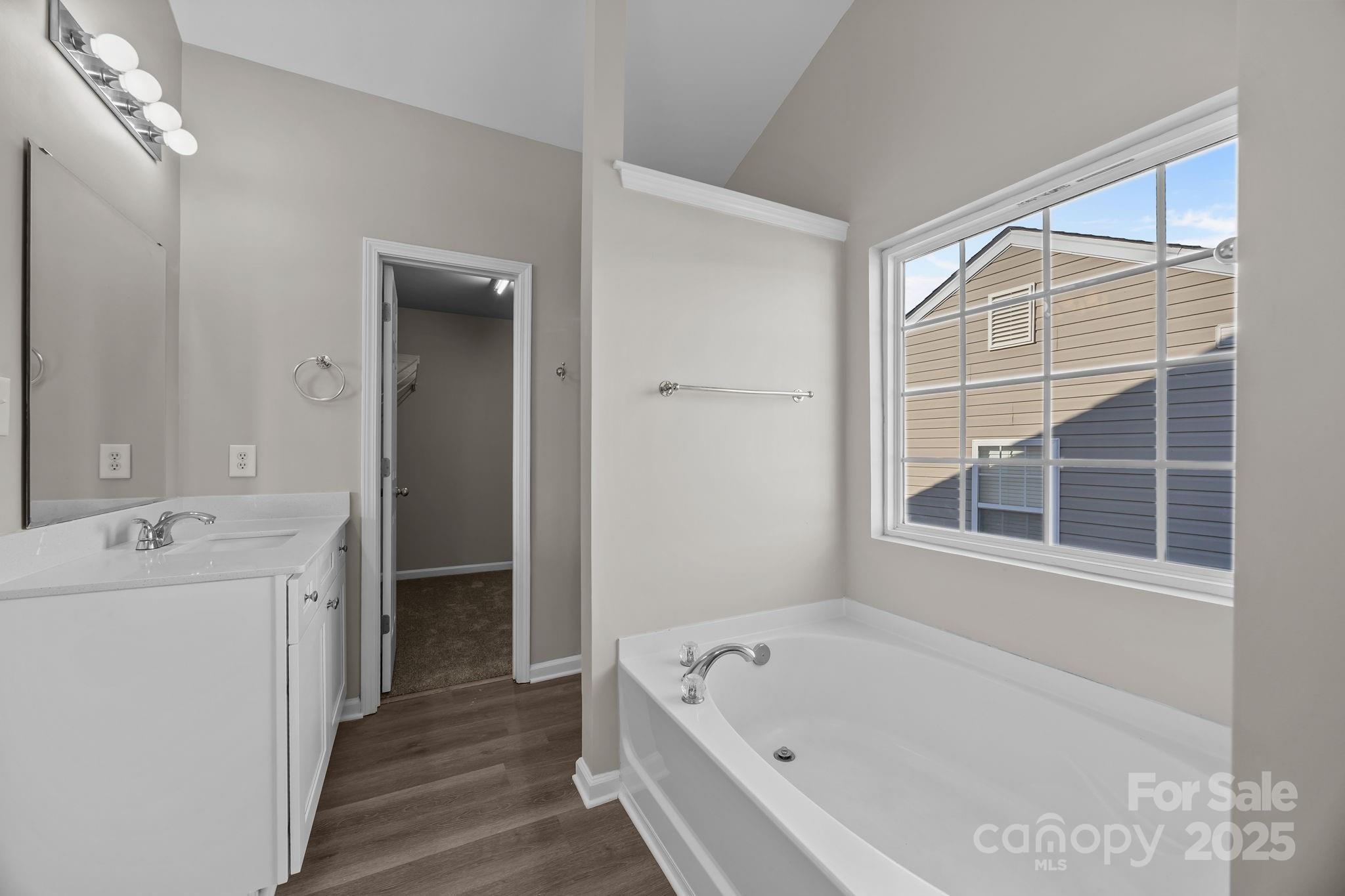 3422 Burnage Hall Road Harrisburg, NC 28075 - Photo 28 of 42 a bathroom with a tub sink and mirror