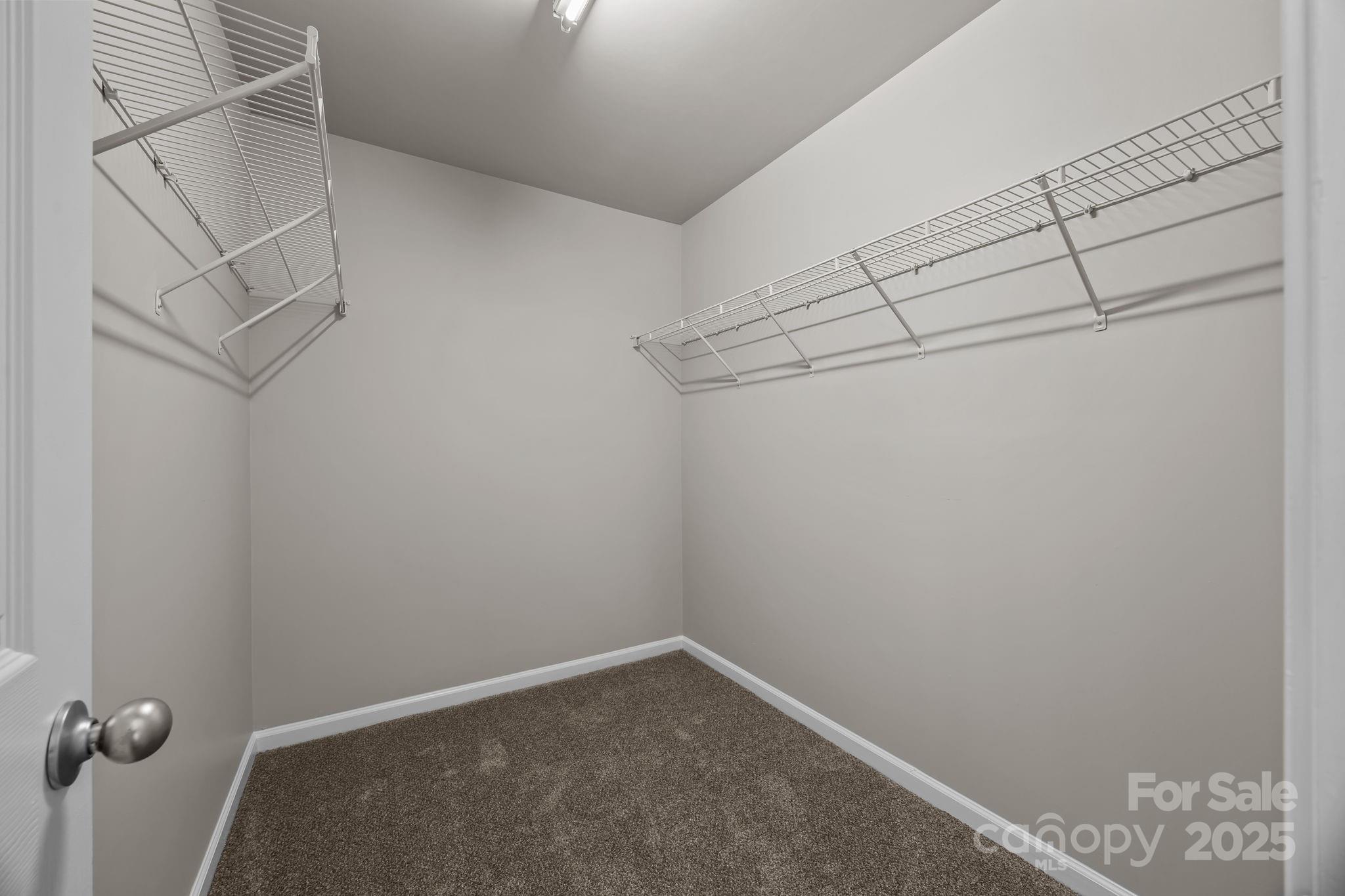 3422 Burnage Hall Road Harrisburg, NC 28075 - Photo 29 of 42 a view of a room with racks on the wall